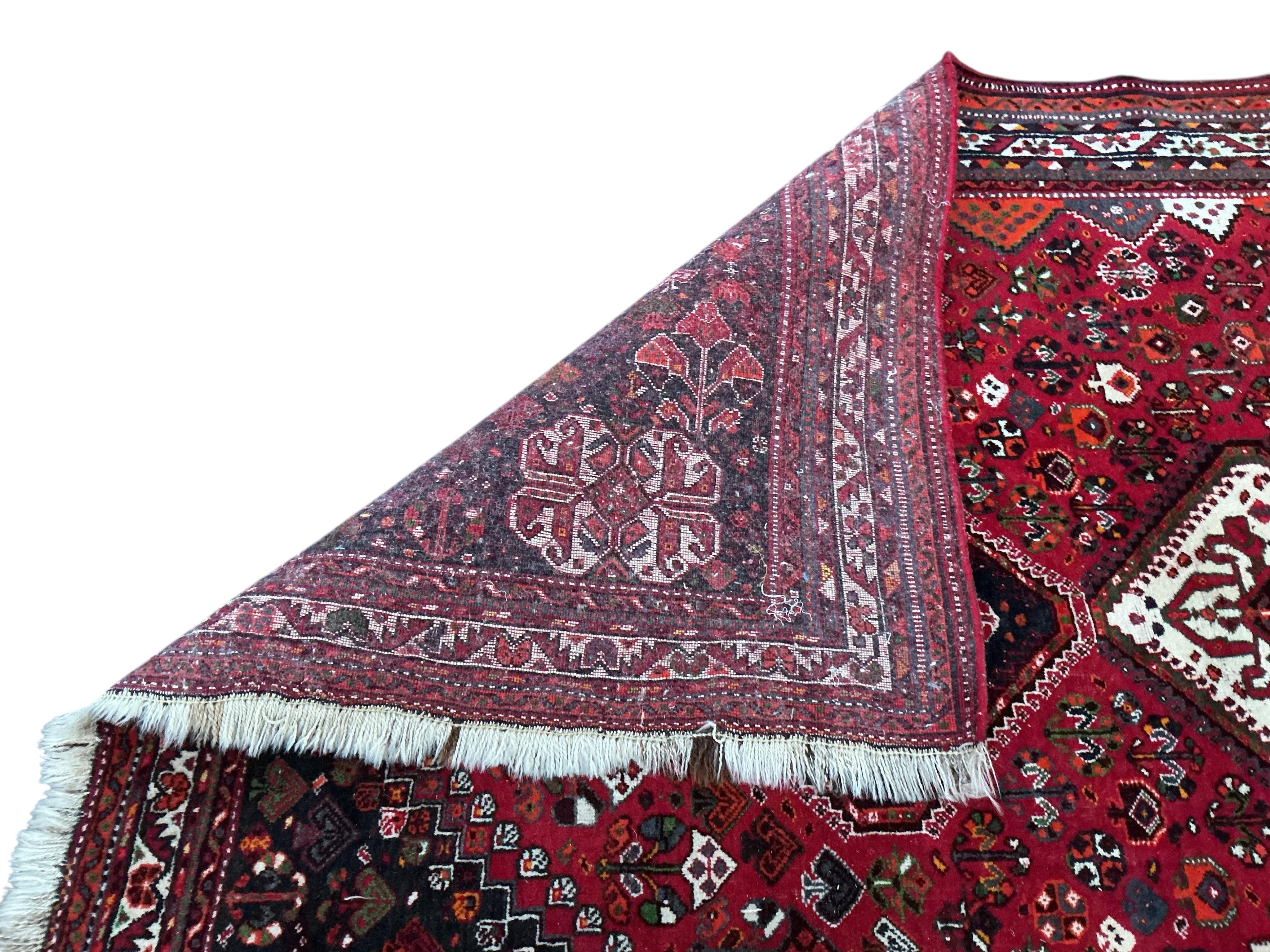 A Hamadan red ground carpet, 256 x 170cm